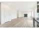 Spacious living room with wood-look floors and a fireplace at 9374 Bahama Ct, Commerce City, CO 80022