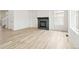 Living room with a modern fireplace and hardwood floors at 9374 Bahama Ct, Commerce City, CO 80022