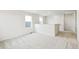 Bright and airy loft space with neutral carpeting and two windows at 9374 Bahama Ct, Commerce City, CO 80022
