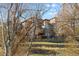Partial view of building behind trees at 7882 Vallagio Ln, Englewood, CO 80112