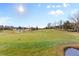 Green golf course with trees and a pond at 7882 Vallagio Ln, Englewood, CO 80112