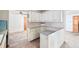 Kitchen with white cabinets, a peninsula counter and tile floor at 2598 Teller St, Lakewood, CO 80214