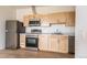 Modern kitchen featuring stainless steel appliances and light wood cabinets at 5702 N Central Park Blvd # 309, Denver, CO 80238