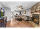 Living room with hardwood floors, stone fireplace, and access to a private patio at 8140 S Fillmore Cir, Centennial, CO 80122