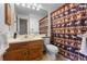 Full bathroom with wood vanity, shower/tub combo, and a decorative shower curtain at 8140 S Fillmore Cir, Centennial, CO 80122