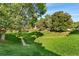 Open green space with grass and mature trees at 8140 S Fillmore Cir, Centennial, CO 80122