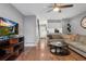 Open living room with hardwood floors, a stone fireplace and a view of the kitchen at 8140 S Fillmore Cir, Centennial, CO 80122