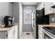 Kitchen with white cabinets, stainless steel appliances, and small window at 8140 S Fillmore Cir, Centennial, CO 80122