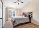 Main bedroom with vaulted ceilings, a ceiling fan, and a large bed at 8140 S Fillmore Cir, Centennial, CO 80122