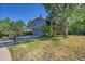 Two-story home with gray siding, a two-car garage, and a lush lawn at 6034 S Niagara Ct, Centennial, CO 80111