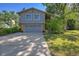 Two-story home with gray siding, a two-car garage and a well-maintained lawn at 6034 S Niagara Ct, Centennial, CO 80111