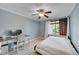 Versatile bedroom with a bed, desk, and ceiling fan at 6034 S Niagara Ct, Centennial, CO 80111