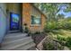 Brick and gray siding ranch home with a welcoming front porch and landscaping at 6034 S Niagara Ct, Centennial, CO 80111