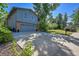 Two-story home with gray siding, a two-car garage and mature landscaping at 6034 S Niagara Ct, Centennial, CO 80111