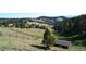 Scenic landscape with distant city views and a shed at 21849 Cabrini Blvd, Golden, CO 80401