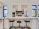 Modern kitchen with white shaker cabinets, marble countertops, and a herringbone backsplash at 314 Castlemaine Ct, Castle Rock, CO 80104