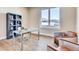 Bright home office features built-in shelving, a glass desk, and two leather chairs at 314 Castlemaine Ct, Castle Rock, CO 80104