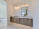 Bathroom with a floating wood vanity and a large mirror at 314 Castlemaine Ct, Castle Rock, CO 80104