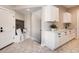 Bright laundry room with white cabinets, a sink, and hexagon tile flooring at 314 Castlemaine Ct, Castle Rock, CO 80104