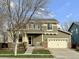 Two-story home with a large front yard and attached two-car garage at 12296 Kalispell St, Commerce City, CO 80603