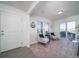 Cozy living room with two armchairs, a side table, and sliding glass door at 45020 Sunflower Ln, Bennett, CO 80102