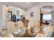 Open dining area with a glass table and hardwood floors at 4924 S Newcombe Ct, Littleton, CO 80127