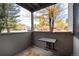 Small patio with a small table and view of trees and neighborhood at 3575 28Th St # 102, Boulder, CO 80301