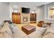 Spacious basement Gathering room features a stone fireplace, built-in shelving, and comfortable seating at 9022 Jason Ct, Boulder, CO 80303