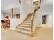 Elegant curved staircase leads from the basement to the upper levels of the home at 9022 Jason Ct, Boulder, CO 80303