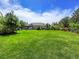 Large grassy backyard with a view of the house and pool at 9022 Jason Ct, Boulder, CO 80303