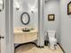 Elegant powder room with a curved vanity, vessel sink, and decorative mirror at 9022 Jason Ct, Boulder, CO 80303