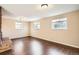 Finished basement room with wood-look flooring and multiple windows at 3390 Teller St, Wheat Ridge, CO 80033