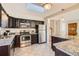 Modern kitchen with stainless steel appliances and granite countertops at 3390 Teller St, Wheat Ridge, CO 80033