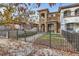 Attractive two-story home with a landscaped front yard and black metal fence at 4553 Osceola St, Denver, CO 80212