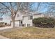 Two-story house with attached garage, landscaping, and a tree in the front yard at 9005 W Bellwood Pl, Littleton, CO 80123