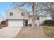 Two-story house with attached garage and landscaping at 9005 W Bellwood Pl, Littleton, CO 80123