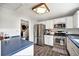 Kitchen features stainless steel appliances and blue countertops at 9005 W Bellwood Pl, Littleton, CO 80123