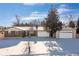 Brick ranch home with attached garage and large yard at 4554 S Lakehurst Way, Littleton, CO 80127