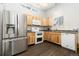 Stainless steel appliances and light wood cabinets in this galley kitchen at 4554 S Lakehurst Way, Littleton, CO 80127