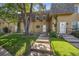 Townhouse exterior with landscaping and a grassy front yard at 7376 E Princeton Ave, Denver, CO 80237