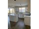 Kitchen with white cabinets, island, and light-colored flooring at 9711 Millstone Ct, Highlands Ranch, CO 80130