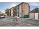Exterior features a two-story building with parking and a dumpster at 865 S Quebec St # 104B, Denver, CO 80247