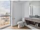 Modern bathroom with a large window offering scenic views at 3575 Chestnut Pl # 606, Denver, CO 80216