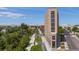 Modern multi-story building with river views and nearby green space at 3575 Chestnut Pl # 606, Denver, CO 80216