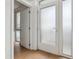 Bright entryway with frosted glass door and light wood floors at 3575 Chestnut Pl # 606, Denver, CO 80216