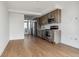 Open living area with light wood floors and access to kitchen at 3575 Chestnut Pl # 606, Denver, CO 80216