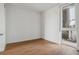 Bright and airy bedroom with wood floors and access to a private balcony at 3575 Chestnut Pl # 606, Denver, CO 80216
