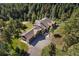 Luxury home nestled in a wooded area with a large driveway and three-car garage at 22759 Mountain Spirit Way, Indian Hills, CO 80454