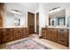 Elegant bathroom with double vanities and large mirrors at 22759 Mountain Spirit Way, Indian Hills, CO 80454