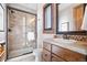 Bathroom with shower, toilet and wood vanity at 22759 Mountain Spirit Way, Indian Hills, CO 80454